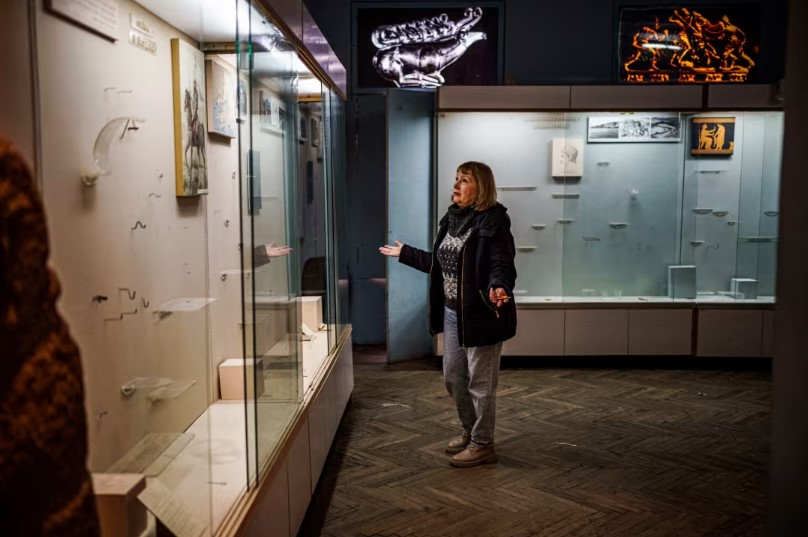 The current director of the Kherson Regional Museum of Local Lore, Olha Honcharova, stands next to empty shelves in one of the halls of the Kherson Regional Museum of Local Lore (photo by NBC News)